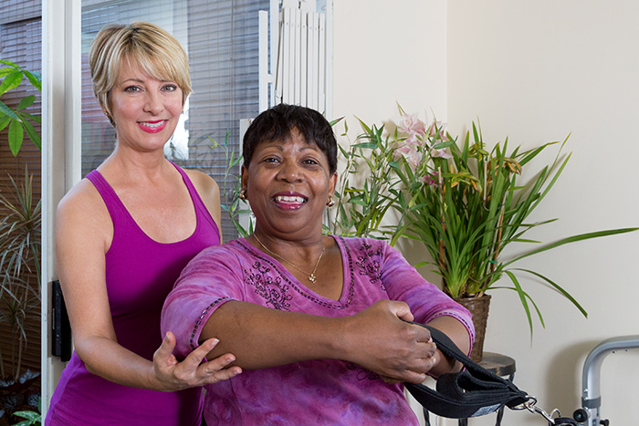 pilates-for-injury-rehabilitation-heal-faster-personalized-reformer-workout-mat-exercises Patte James with injury rehabilitation client doing shoulder and chest exercises on the Reformer